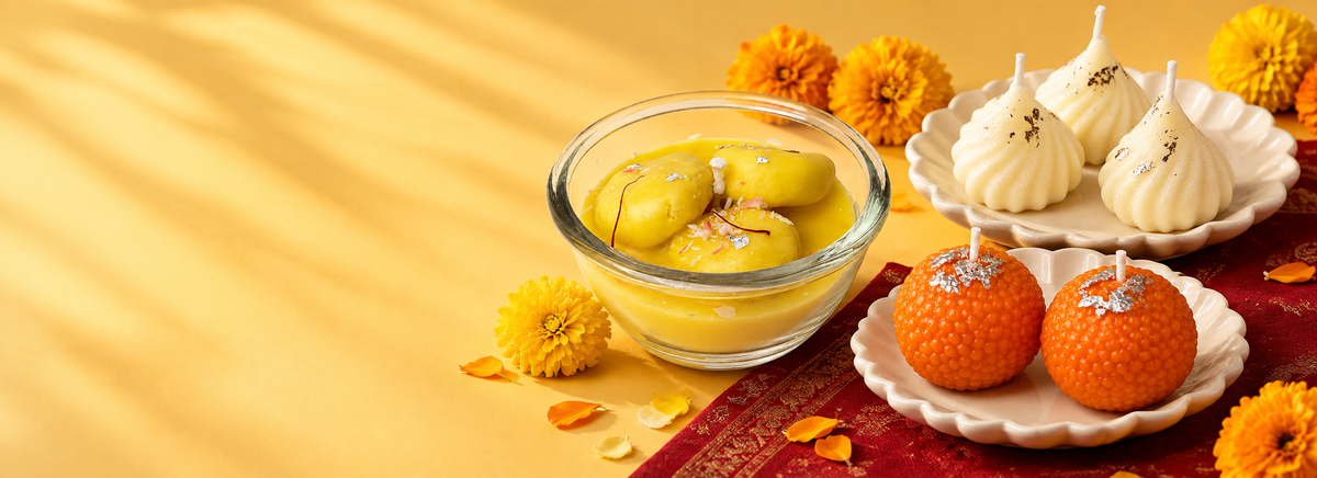 Rasmalai, modak and ladoo candles with marigolds